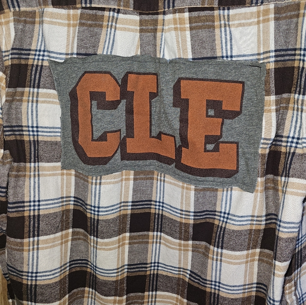 Large Brown Fannel Shirt With A CLE Graphic Tee Shirt On The Back